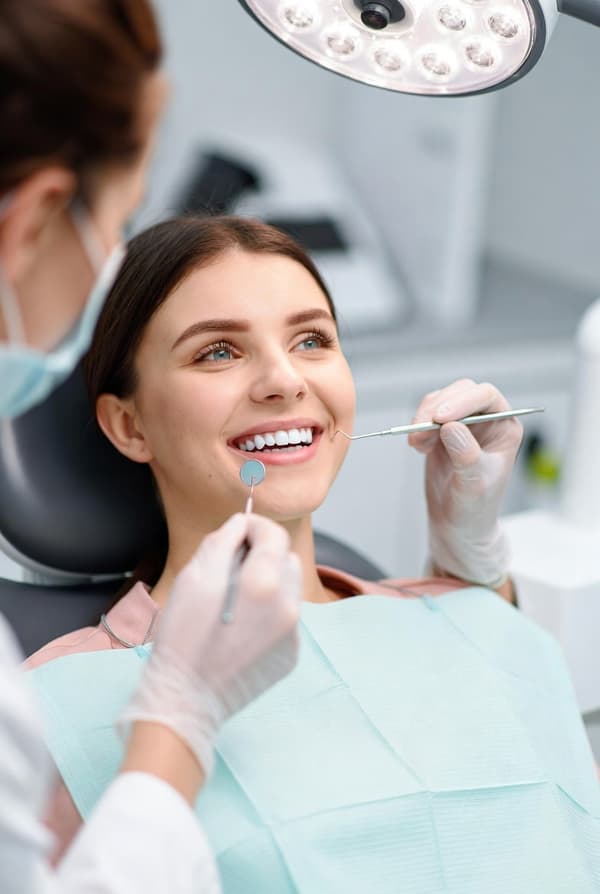 Dentist examining a patient in a treatment chair