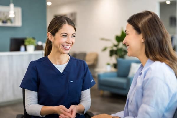 Dental team member speaking with a patient